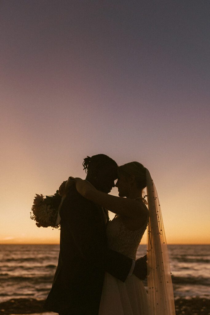 sunset wedding photos of couple at sunset cliffs