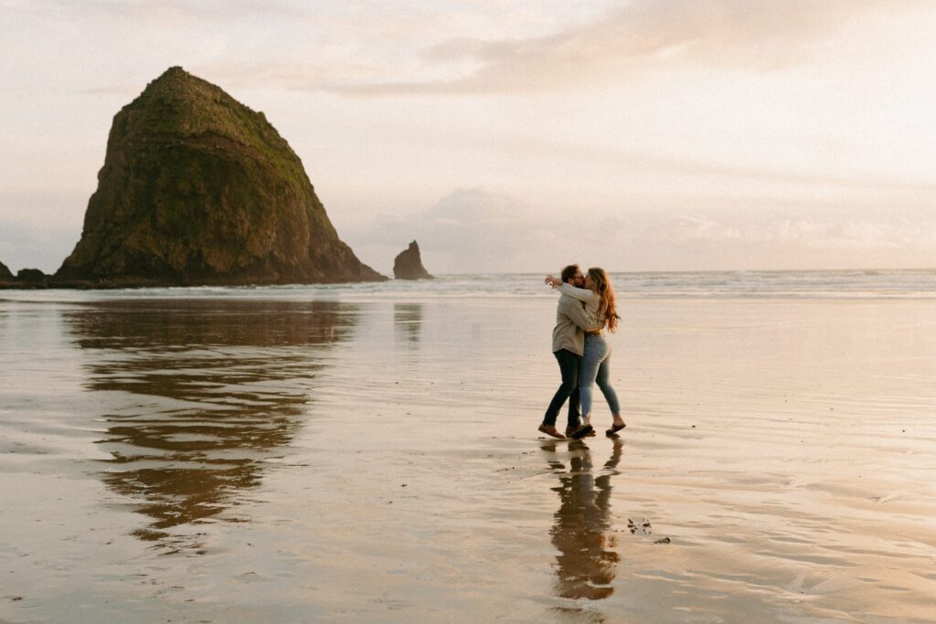 couple hugging during their cannon beach engagement photos